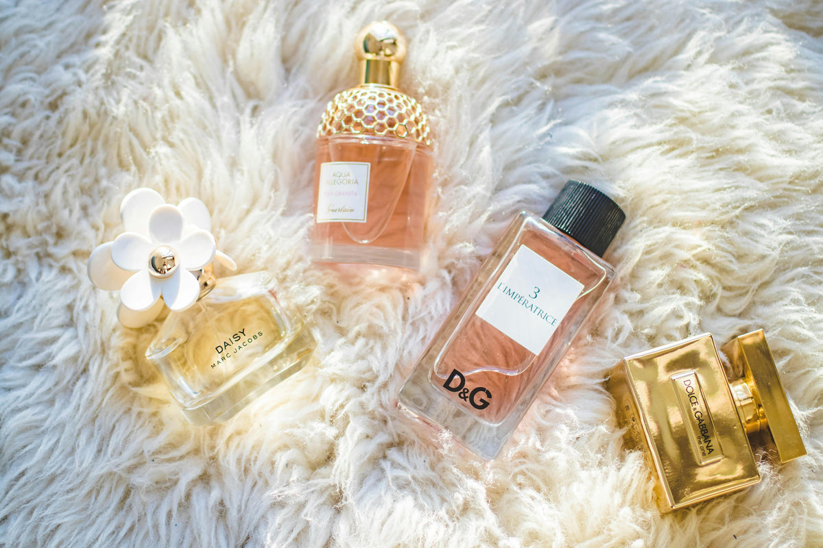 Women's perfume bottles on a soft white rug